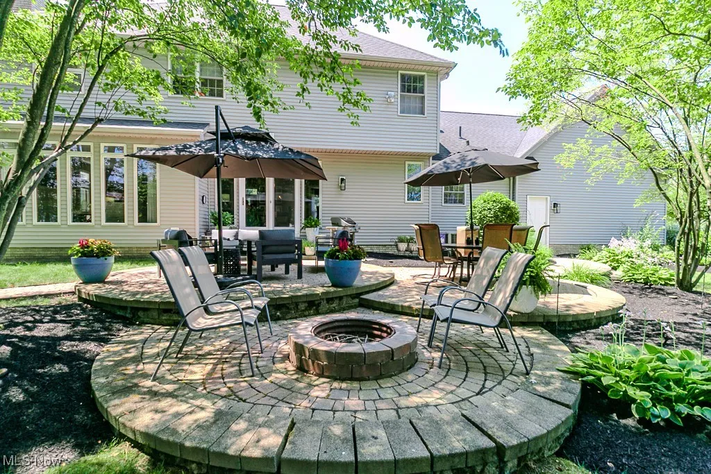 Brick paver patio featuring an outdoor fire pit