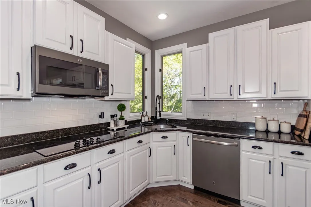 Modern Kitchen, with granite countertops, and white backsplash