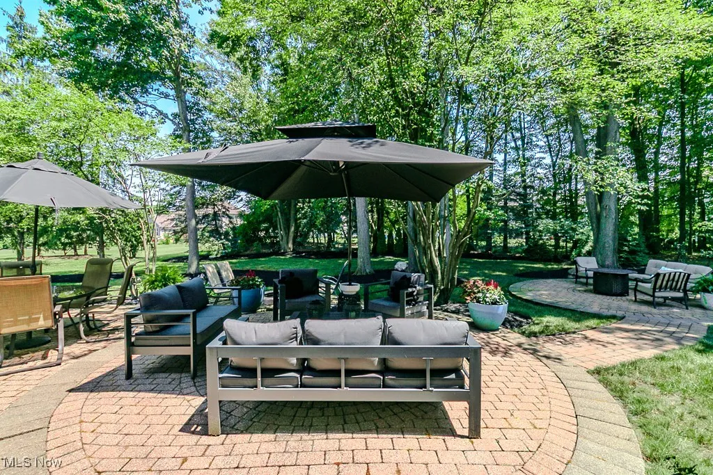 Brick paver patio with an outdoor hangout area and outdoor dining space