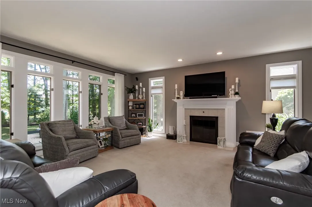 Carpeted Family Room with recessed lighting and a gas log fireplace