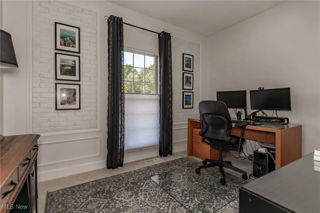 1st floor Bedroom or Home office featuring a decorative wall and wainscoting