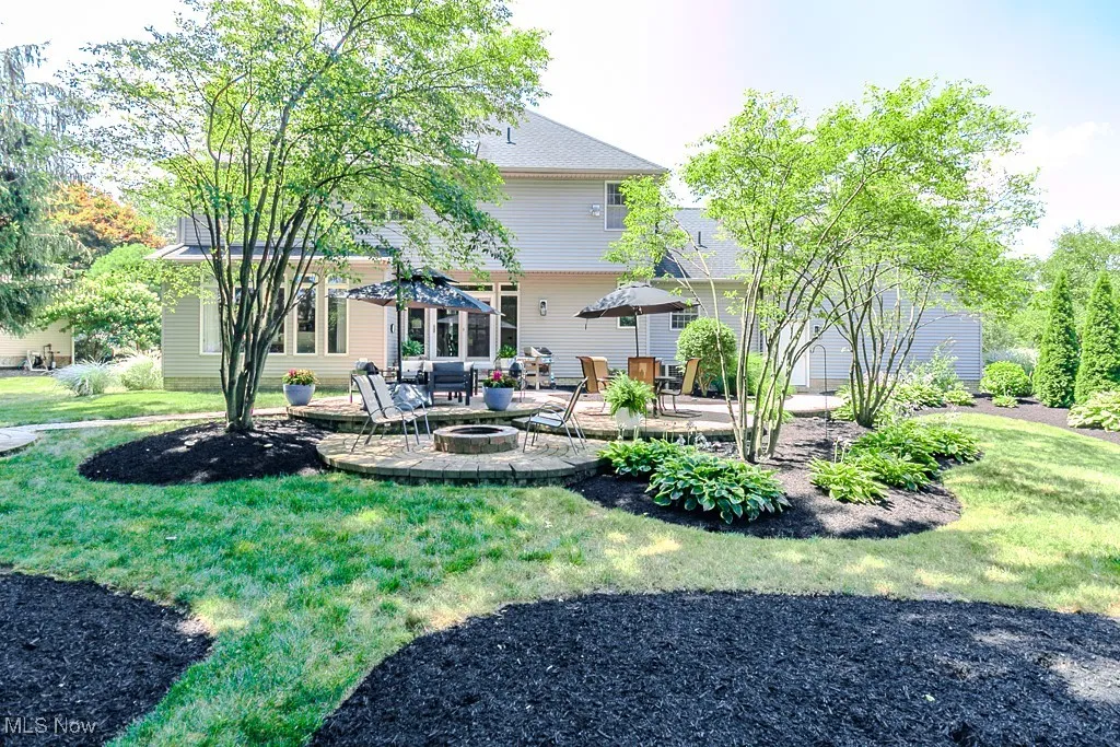Back of property with freshly mulched beds
