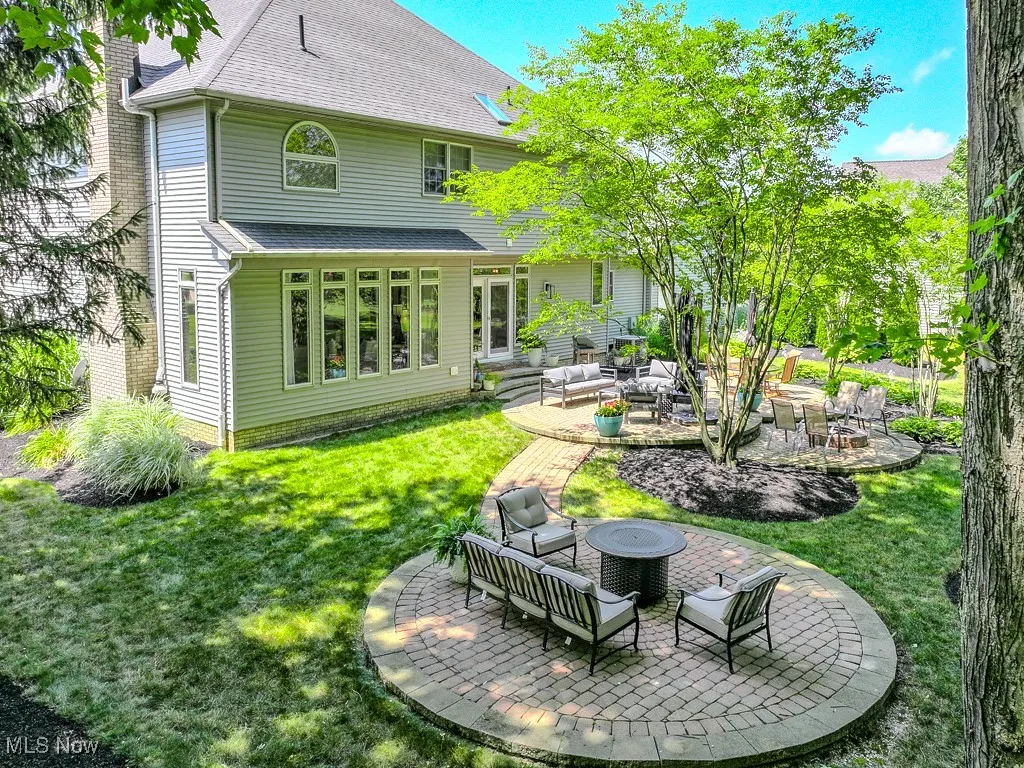 Back of home with an outdoor living space