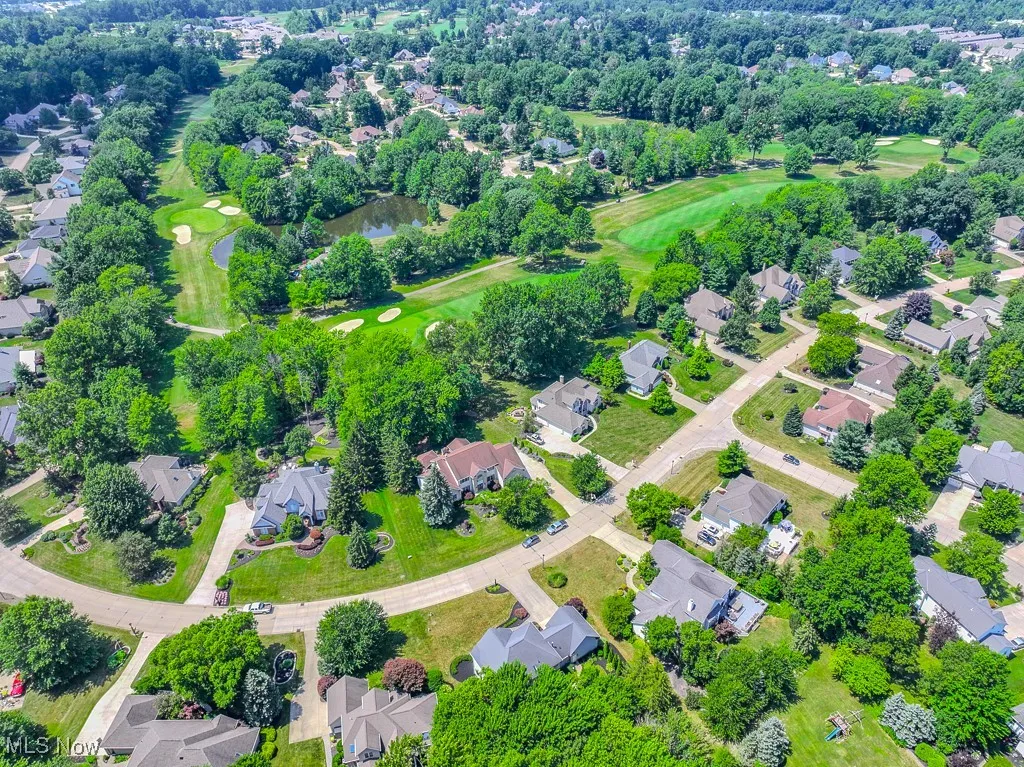 Sky view of Quail Hollow neighborhood with lush trees and  36 holes of golf