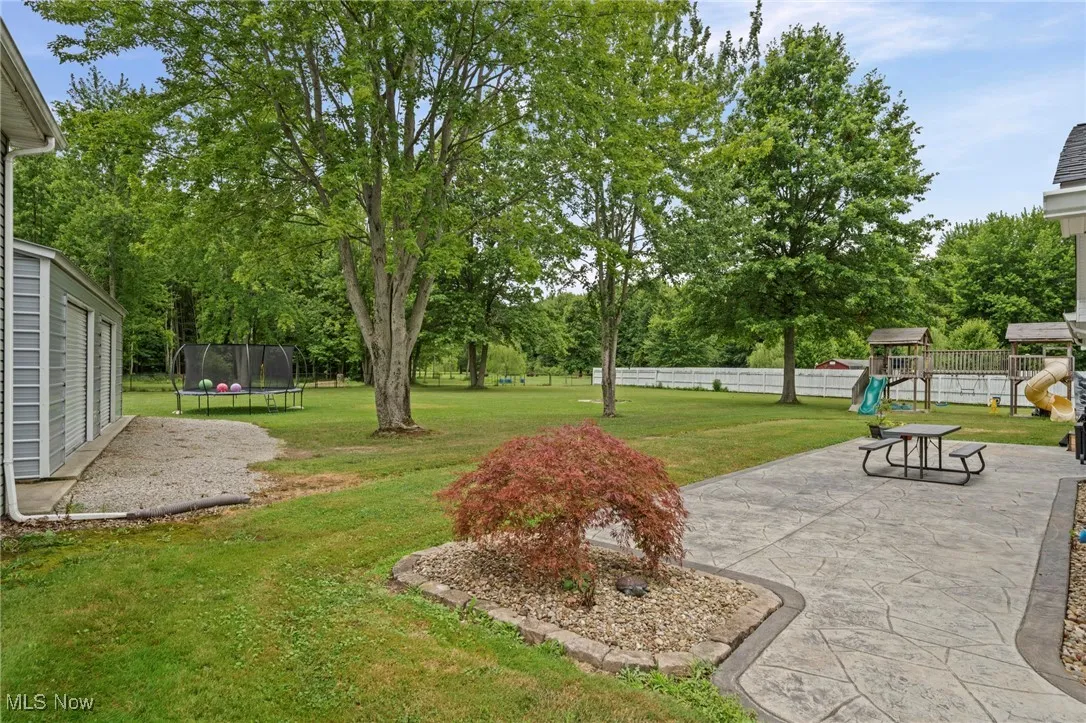 View of yard featuring a patio area, and view of scattered trees