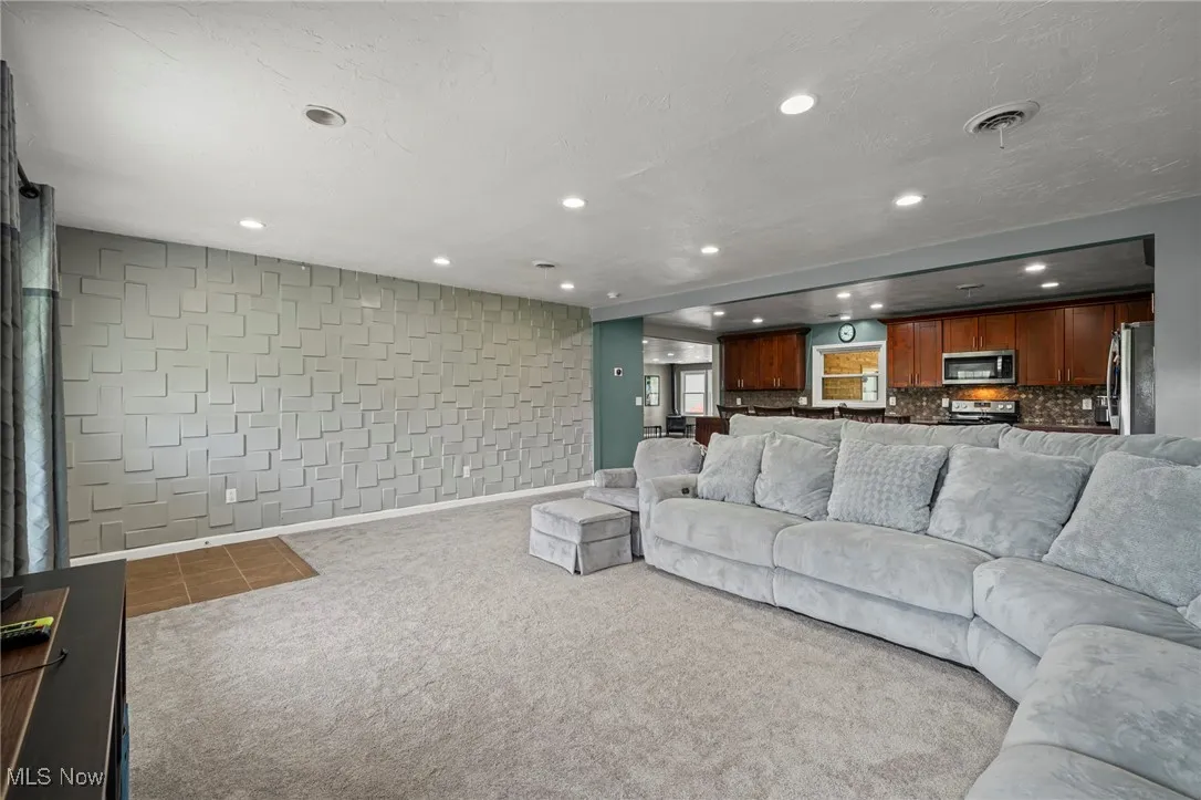 Carpeted living room featuring recessed lighting