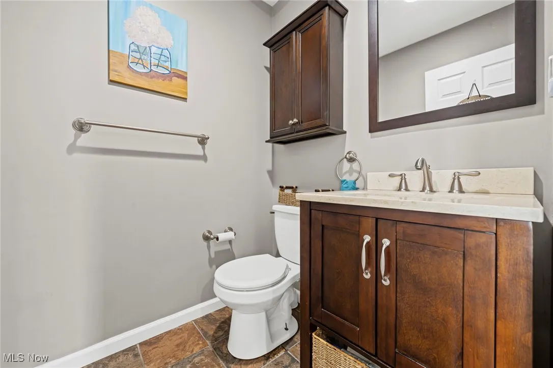 Bathroom with vanity and stone finish flooring