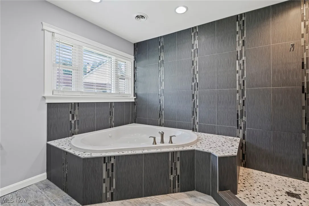 Master Bathroom with a jetted tub, recessed lighting, and a shower