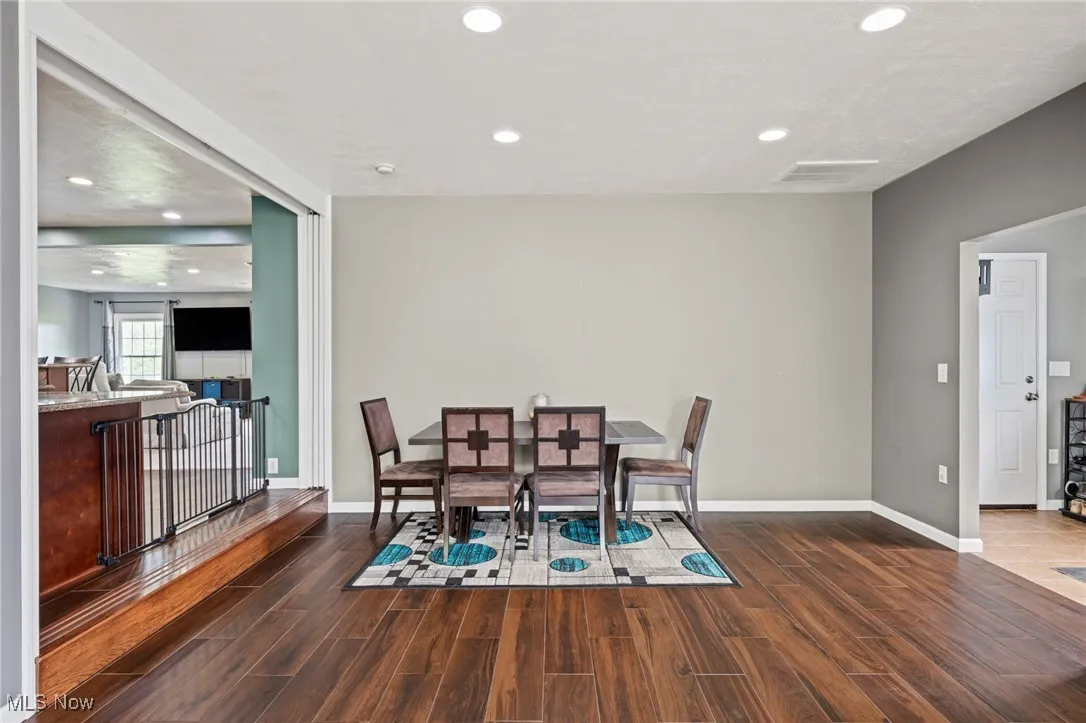 Dining room featuring wood finished floors and recessed lighting