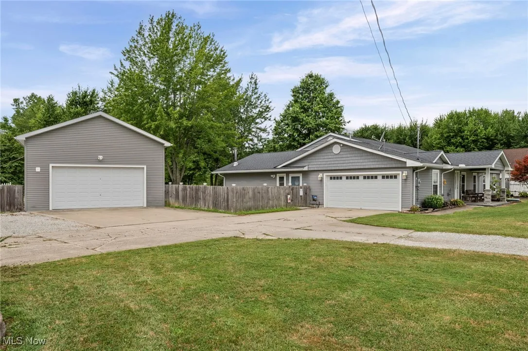 Ranch-style house with concrete driveway and a porch