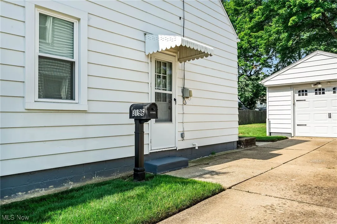 Property entrance with concrete driveway