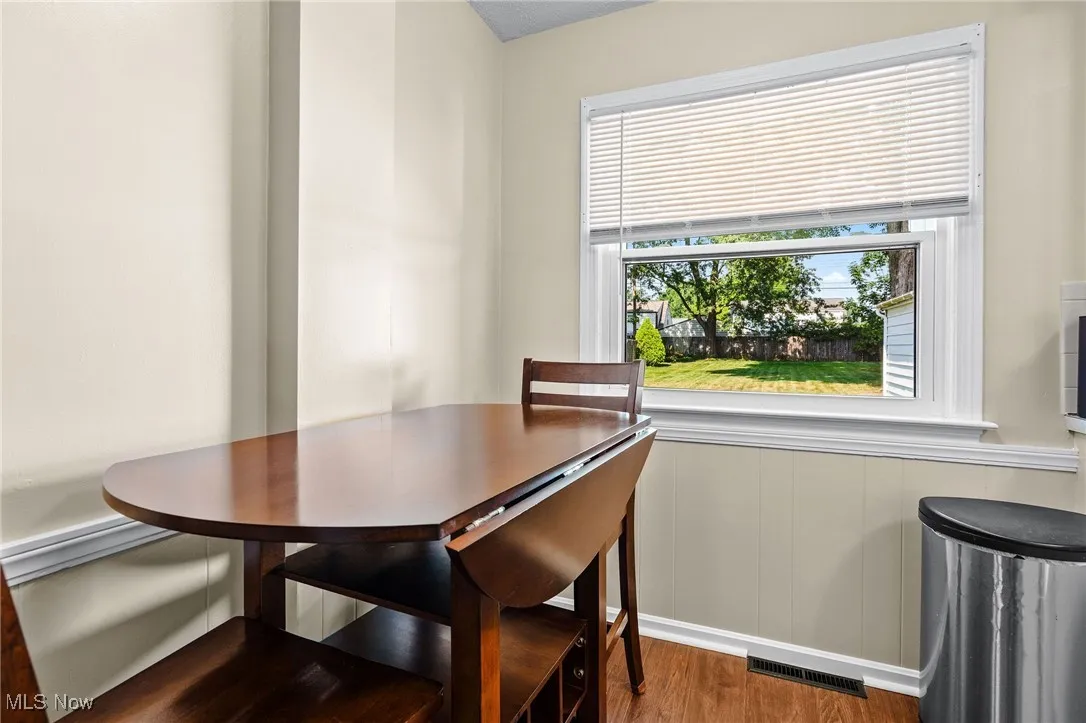 Dining area of the kitchen with newer laminate flooring, wainscoting, and newer windows. The dinette area can seat 4 people