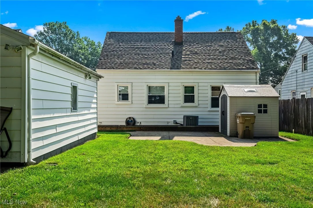 Rear view of the house with the patio and storage shed