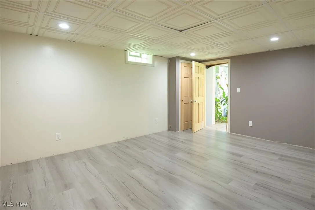 Spare room with recessed lighting, light wood-style flooring, and an ornate ceiling