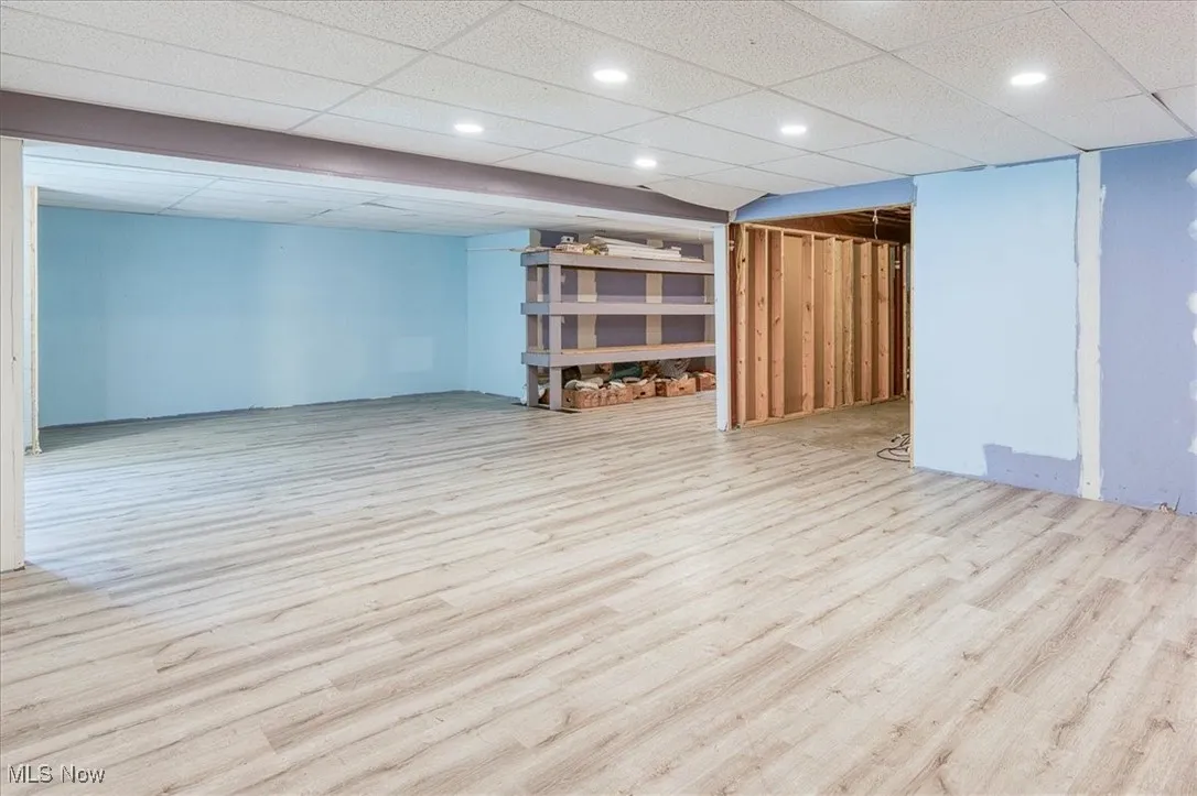 Finished below grade area featuring wood finished floors and recessed lighting