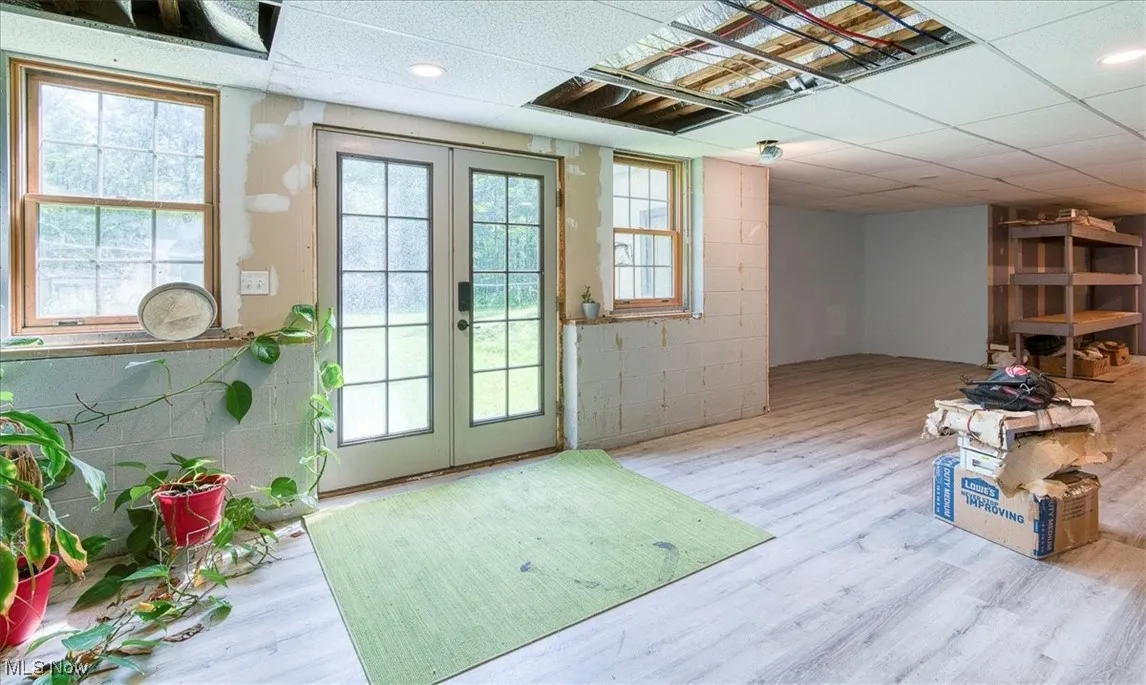 Entryway with french doors, a drop ceiling, and wood finished floors
