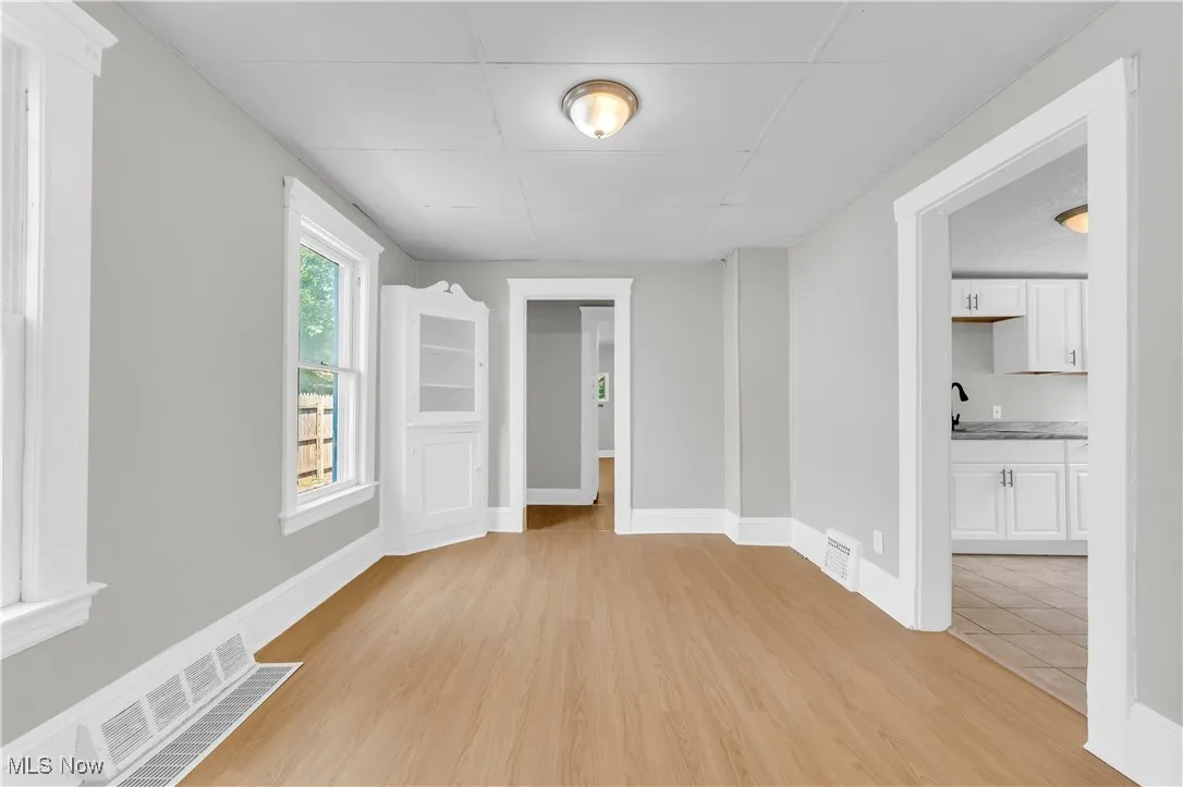 Spare room featuring a drop ceiling and light wood-style flooring