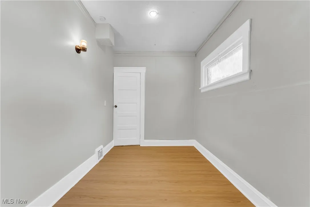 Empty room featuring baseboards and light wood-style floors