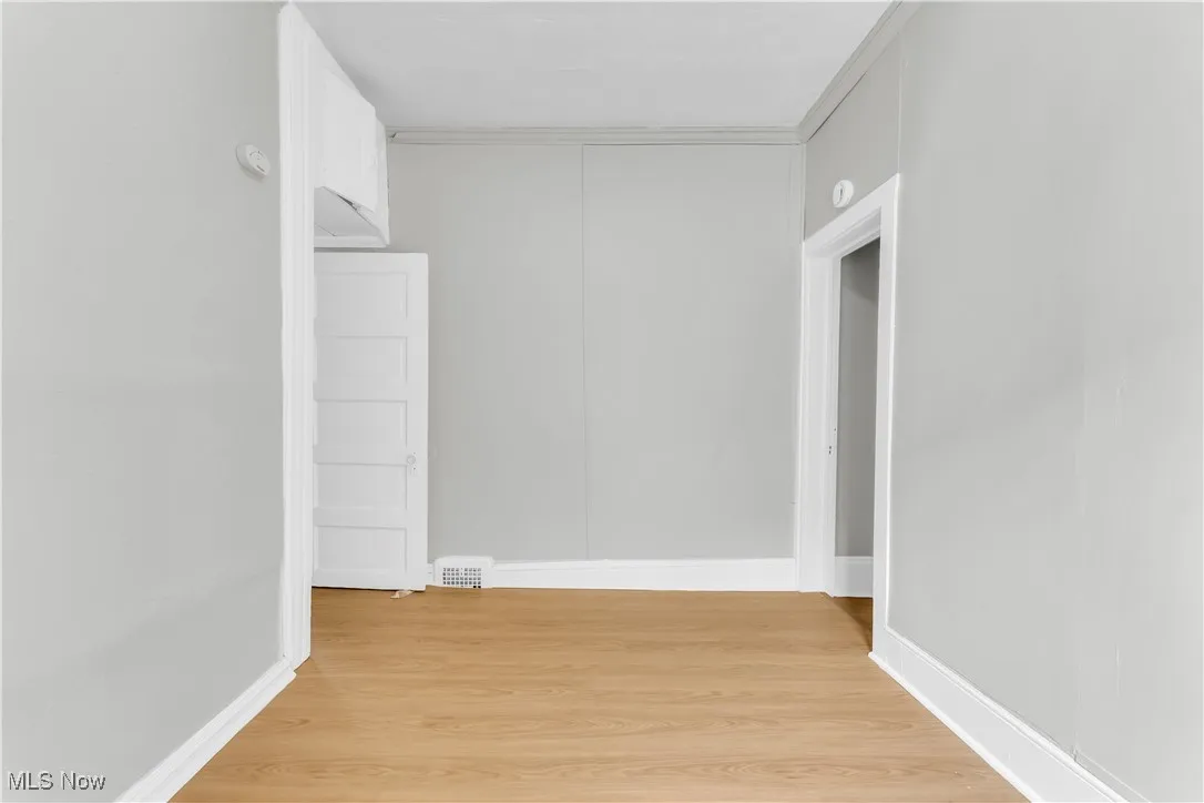 Unfurnished room with light wood-type flooring and baseboards