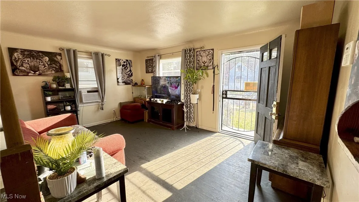 Living room featuring wood finished floors and cooling unit