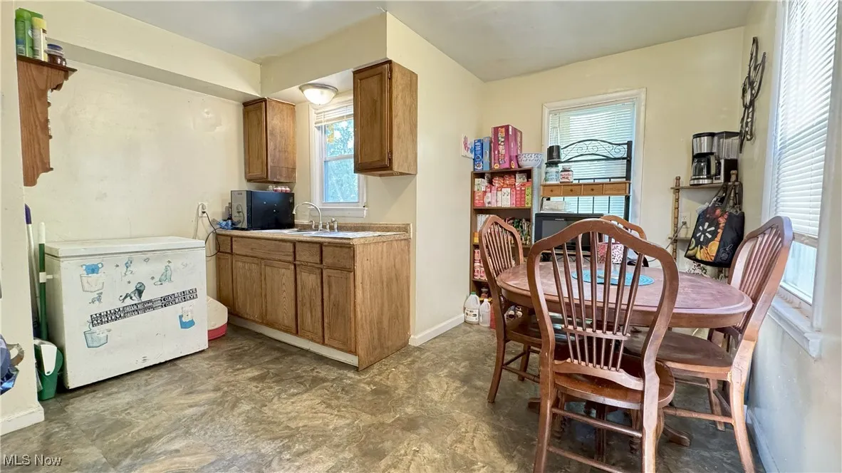 Dining area with baseboards and dark floors