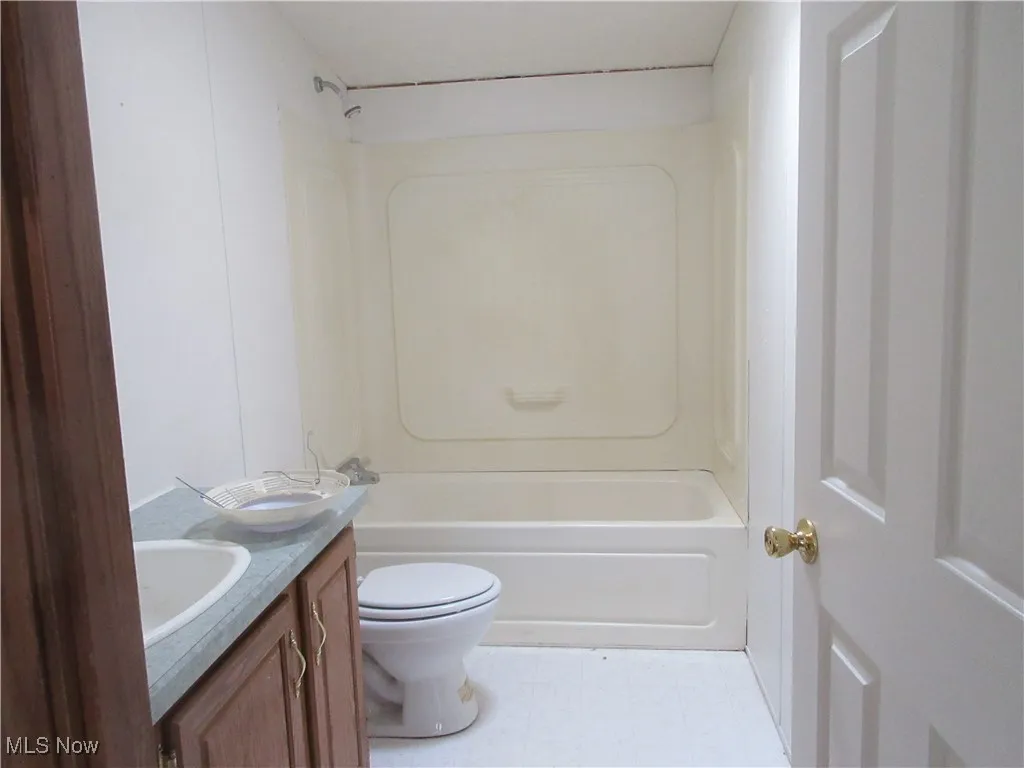 Bathroom with vanity and shower / bath combination