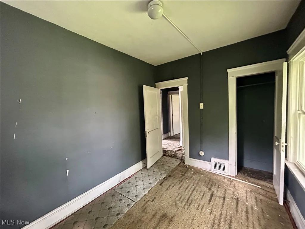 Unfurnished bedroom with baseboards