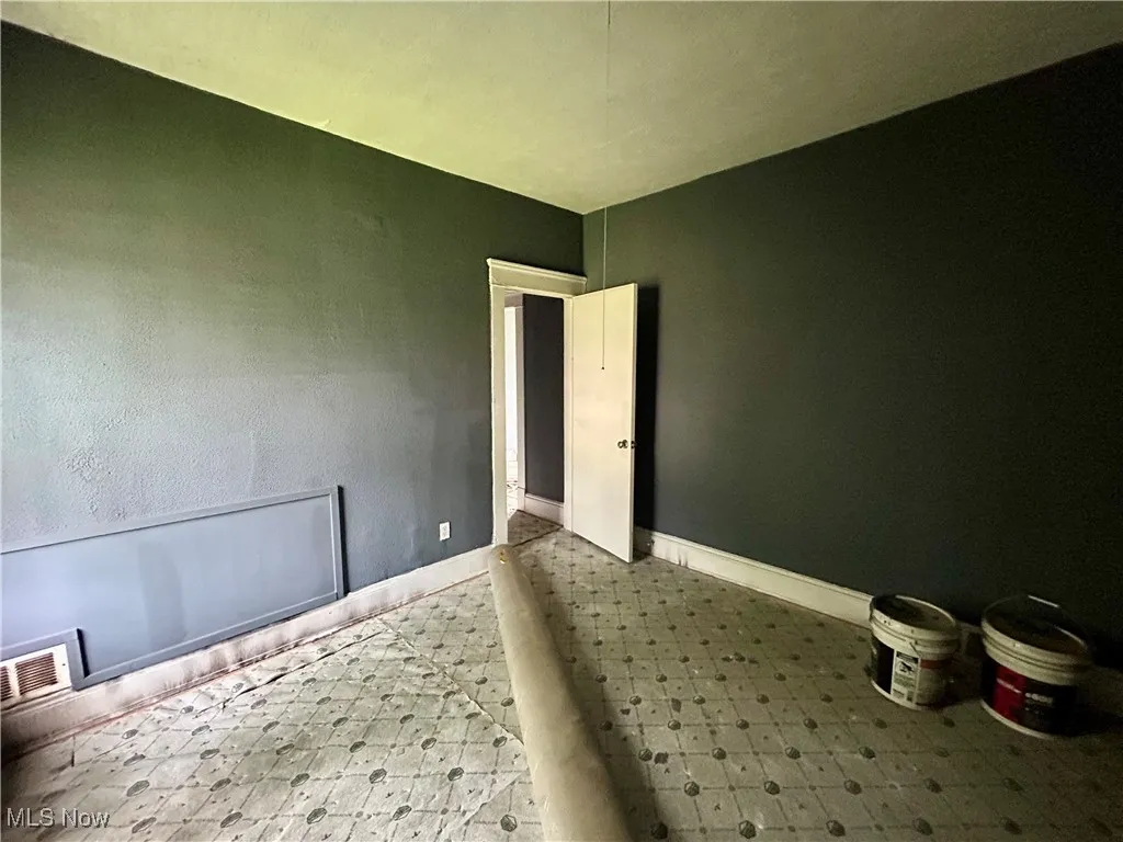 Spare room featuring baseboards