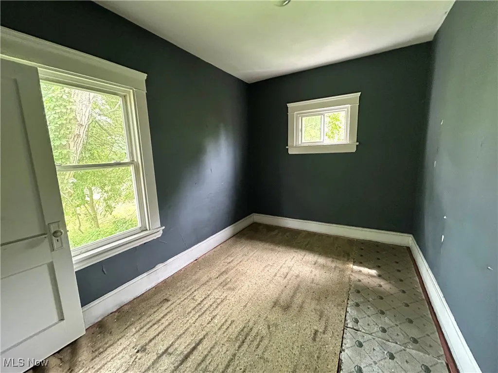 Unfurnished room featuring baseboards