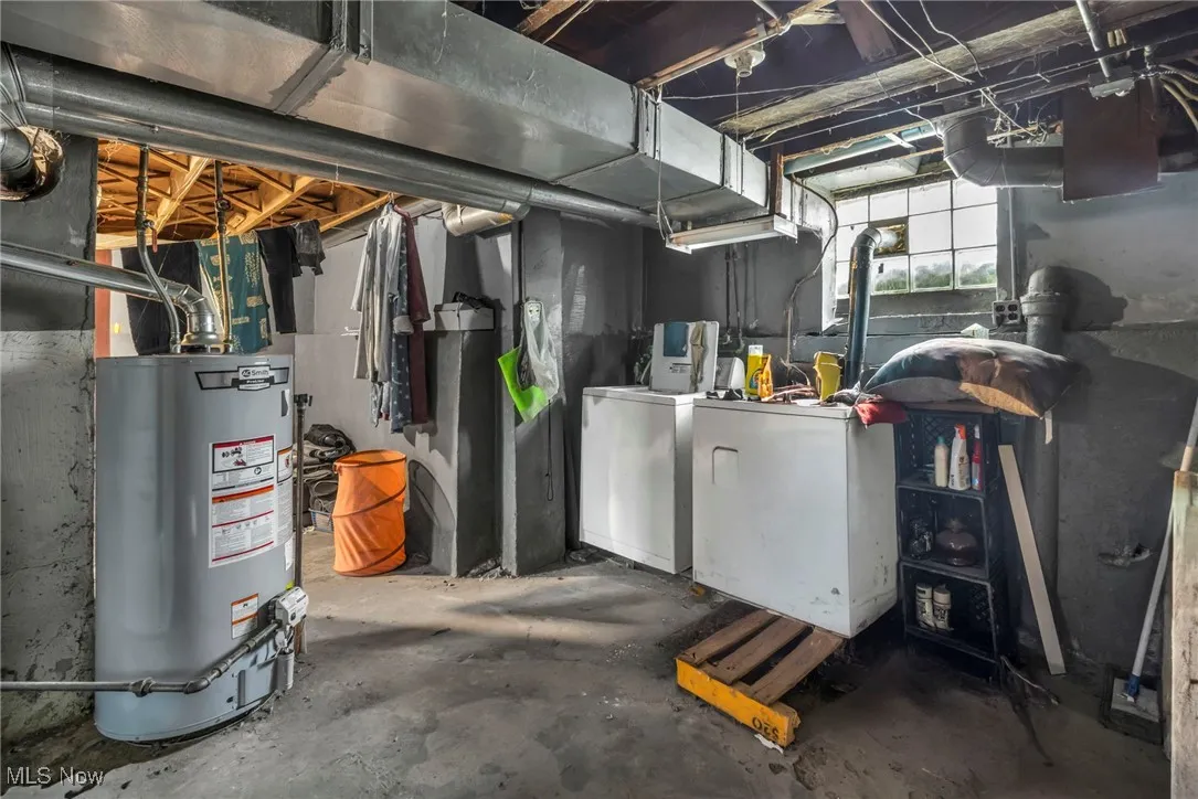Below grade area with washer and clothes dryer and water heater