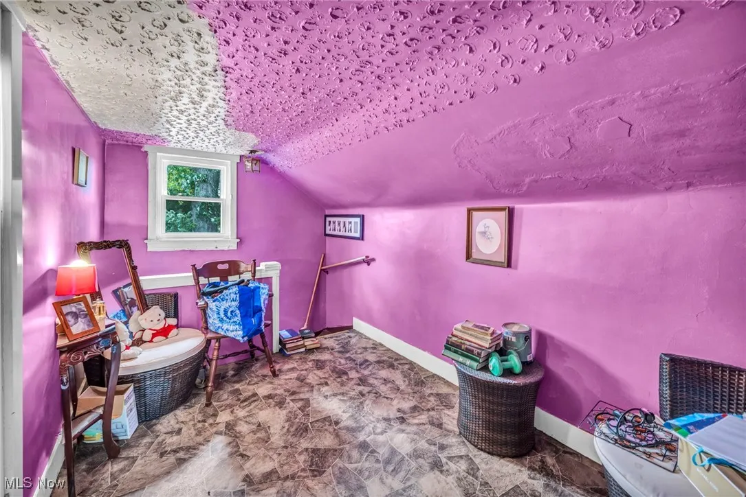 Playroom featuring baseboards and vaulted ceiling