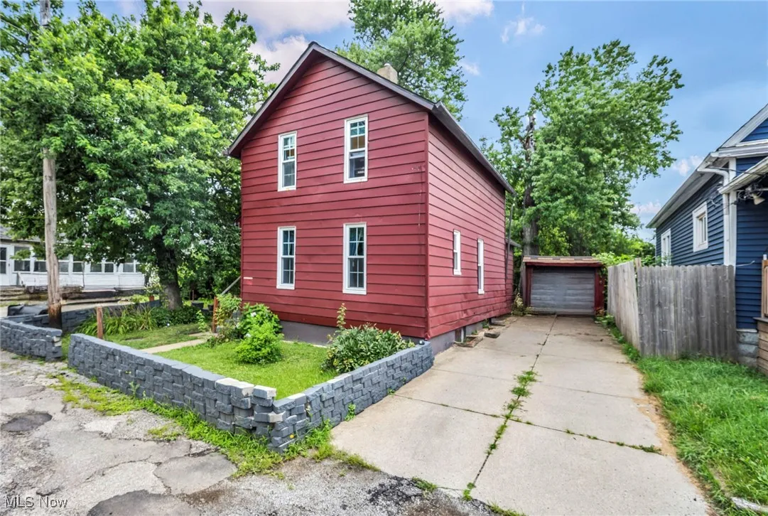 View of side of property with a garage and an outdoor structure