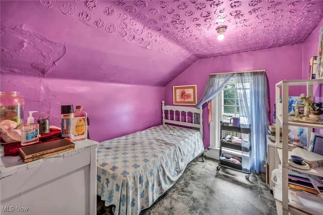 Bedroom with lofted ceiling