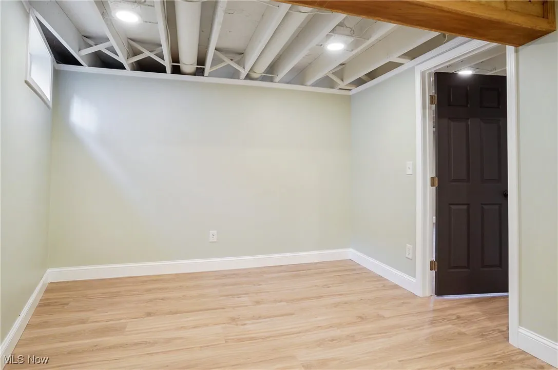 Finished basement featuring light wood-style flooring