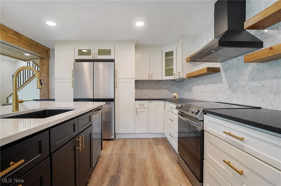 Kitchen with open shelves, wall chimney exhaust hood, stainless steel appliances, white cabinetry, and recessed lighting
