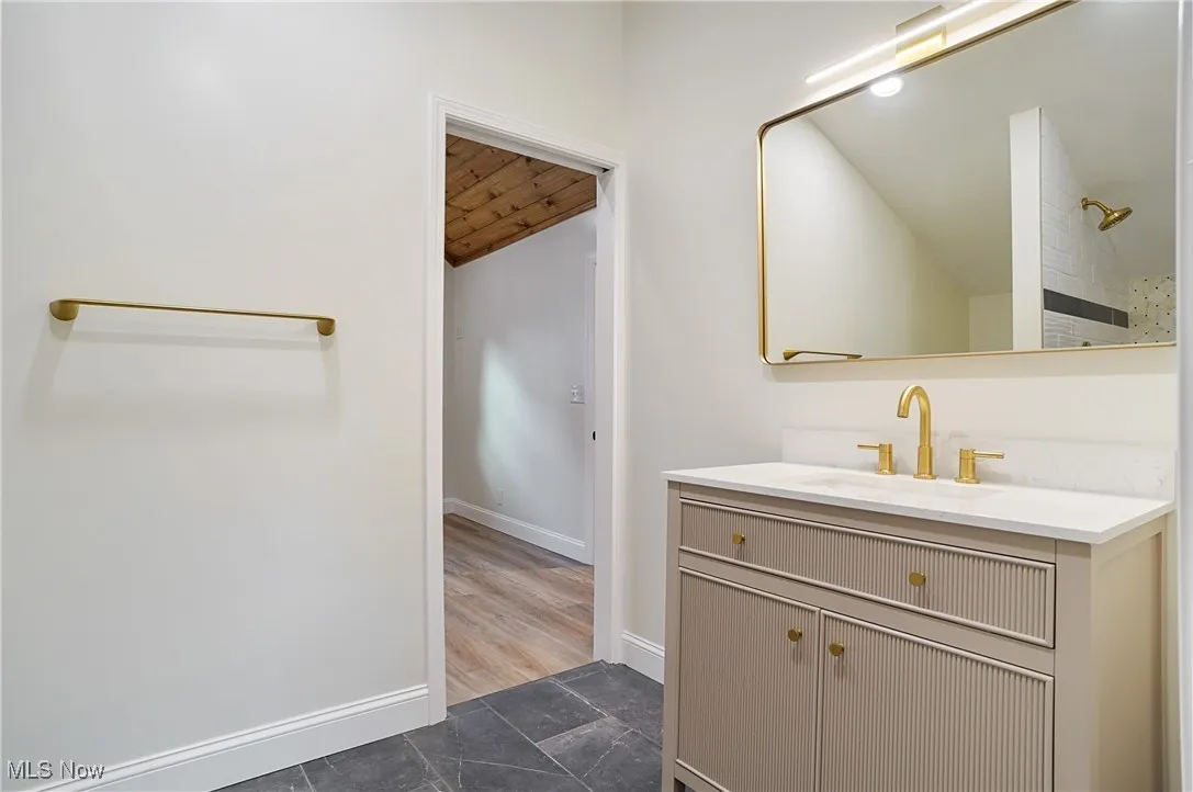 Full bath with vanity, lofted ceiling, wood ceiling, and a shower