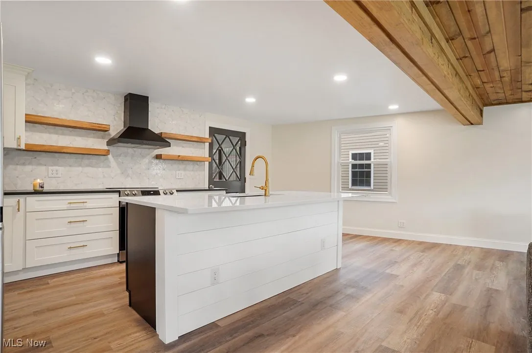 Kitchen with open shelves, backsplash, wall chimney exhaust hood, stainless steel electric range oven, and recessed lighting
