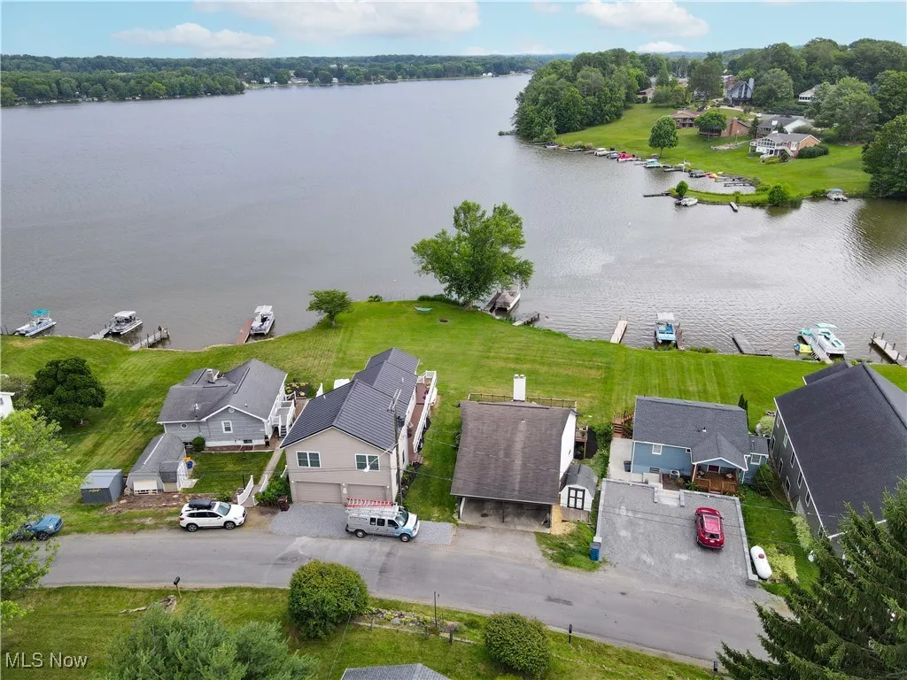 Aerial view of residential area featuring a large body of water