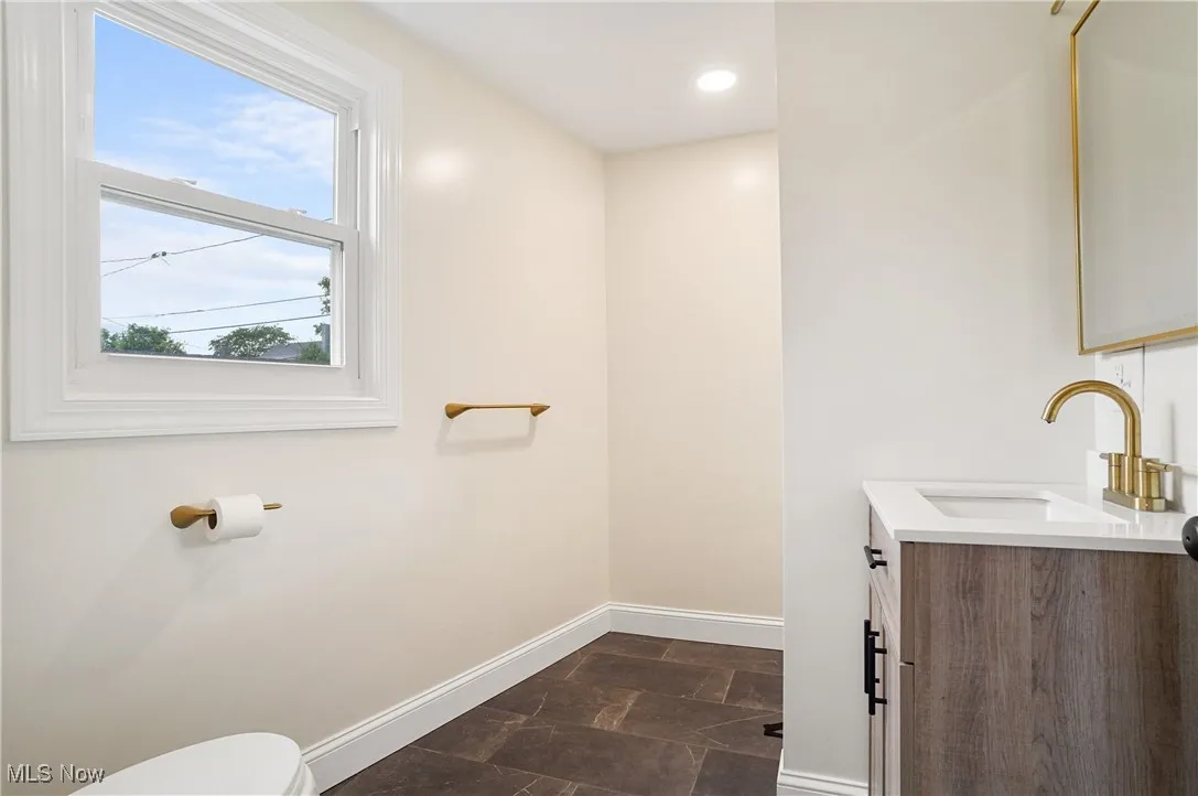 Half bath featuring vanity and recessed lighting