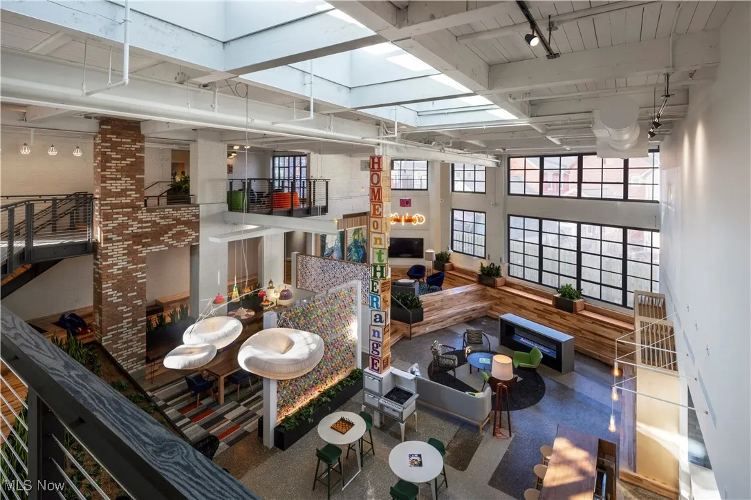 Community living and working spaces featuring oversized west facing windows and multiple seating options
