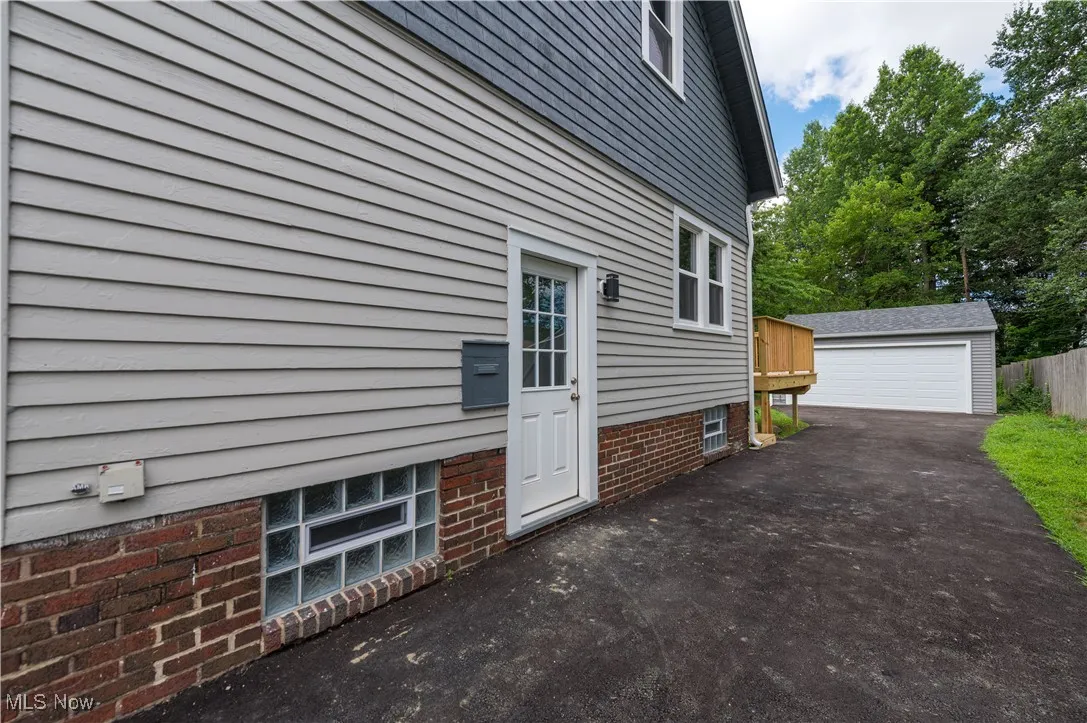 View of property exterior featuring an outdoor structure and a garage