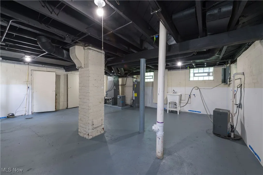 Below grade area featuring gas water heater and heating unit