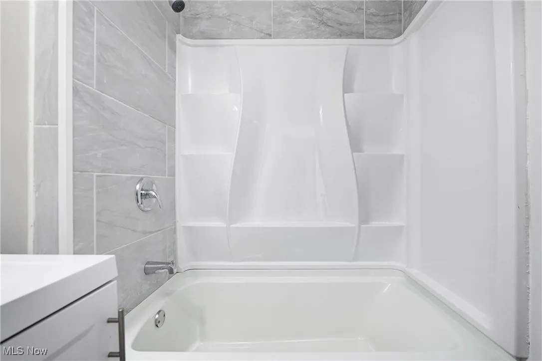 Full bath with shower / bath combination and vanity