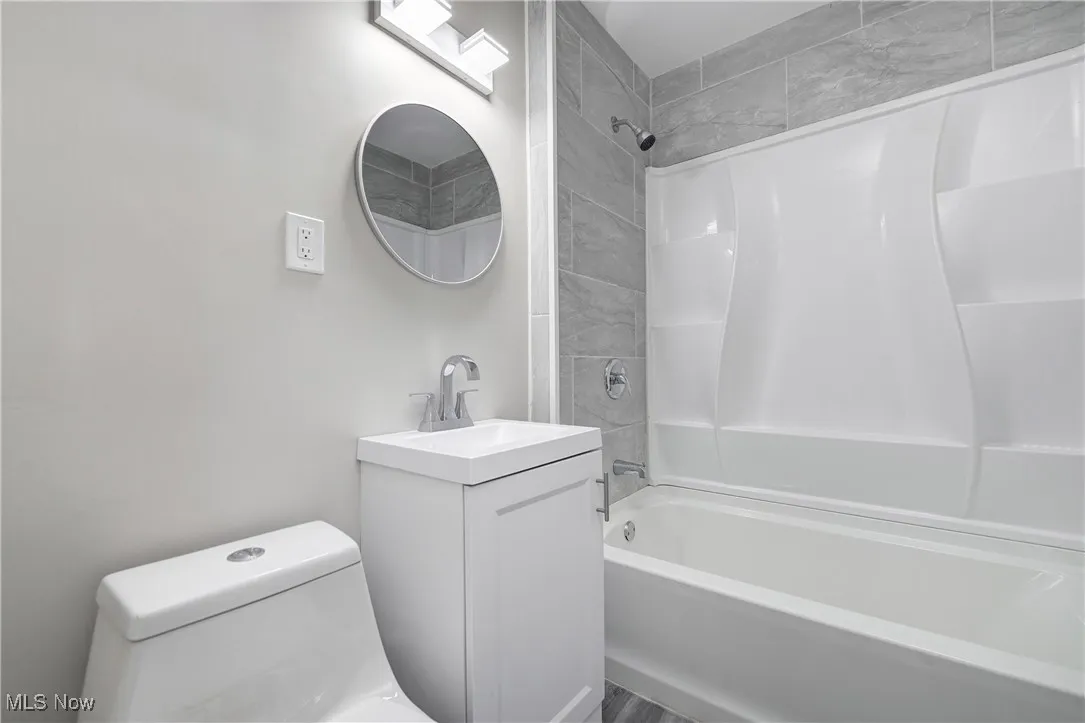 Full bathroom with vanity and bathing tub / shower combination