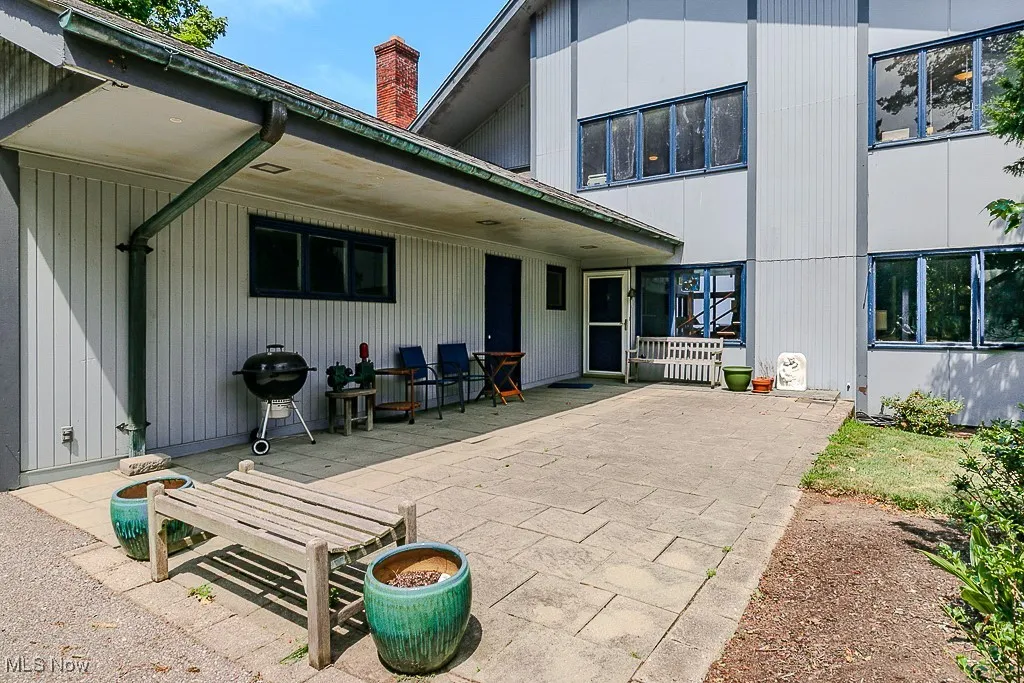 Rear view of property with a patio and a chimney