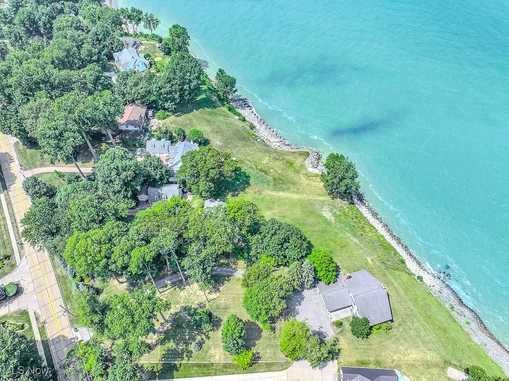 Aerial view of property's location featuring unending shoreline
