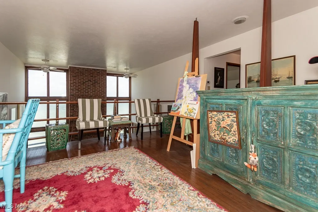 Living area featuring wood finished floors and ceiling fan