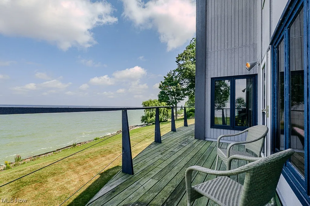Balcony with view of water and beach