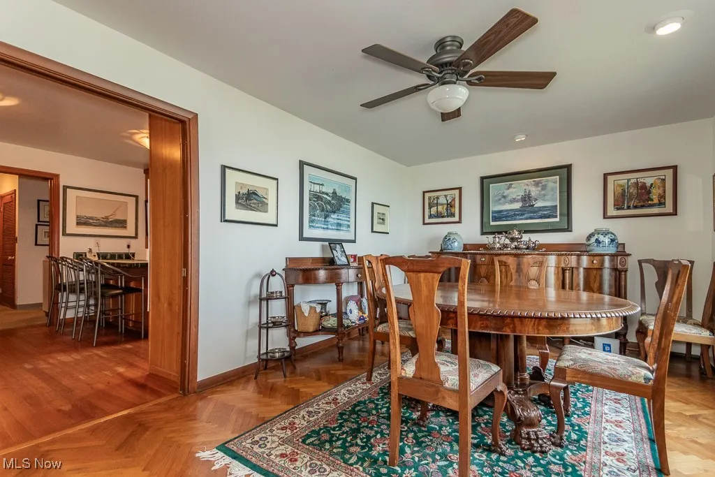 Dining space with a ceiling fan and baseboards