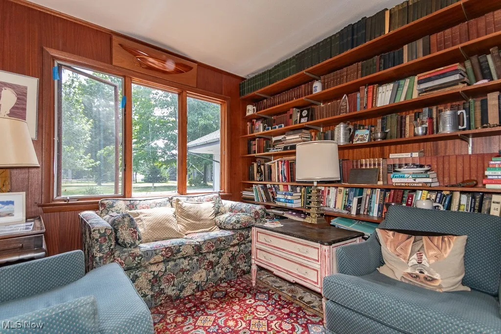 Sitting room with wood walls and built in shelves